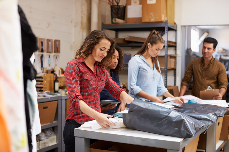 staff packing garments for delivery