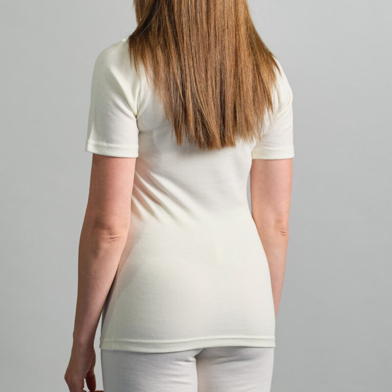 back view of a lady wearing white Merino Skins unisex short sleeve crew neck